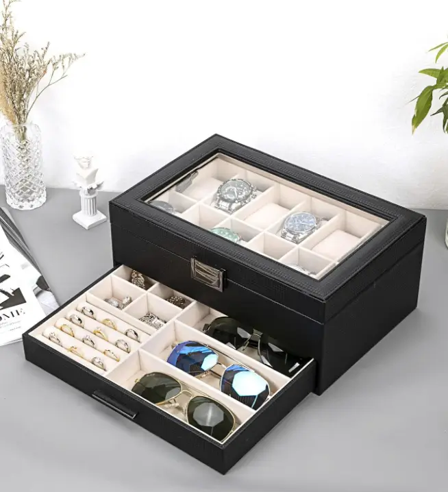 A black Voova watch case with a glass lid, twelve cushioned slots and a drawer below